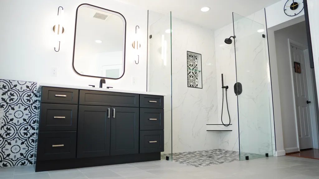 Bathroom with navy vanity, patterned cement floor tile and a marble shower